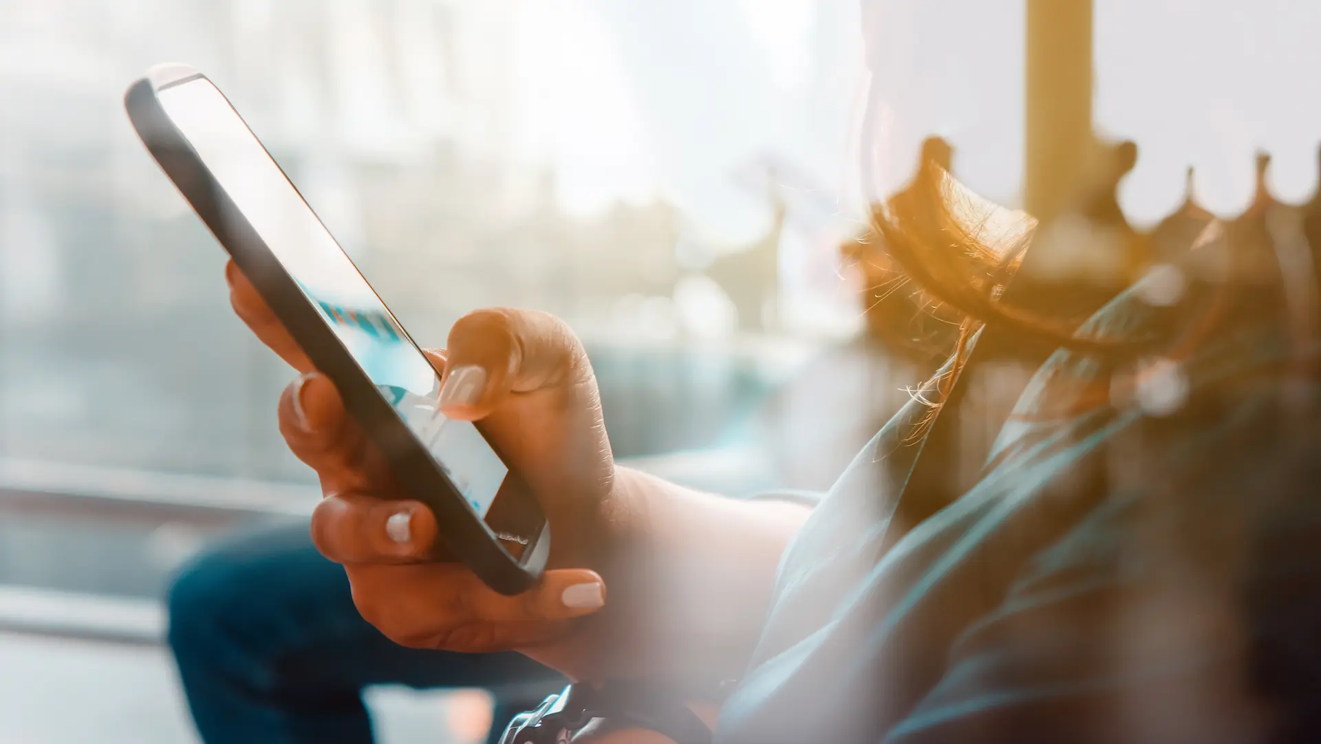 Person using smartphone with bright background